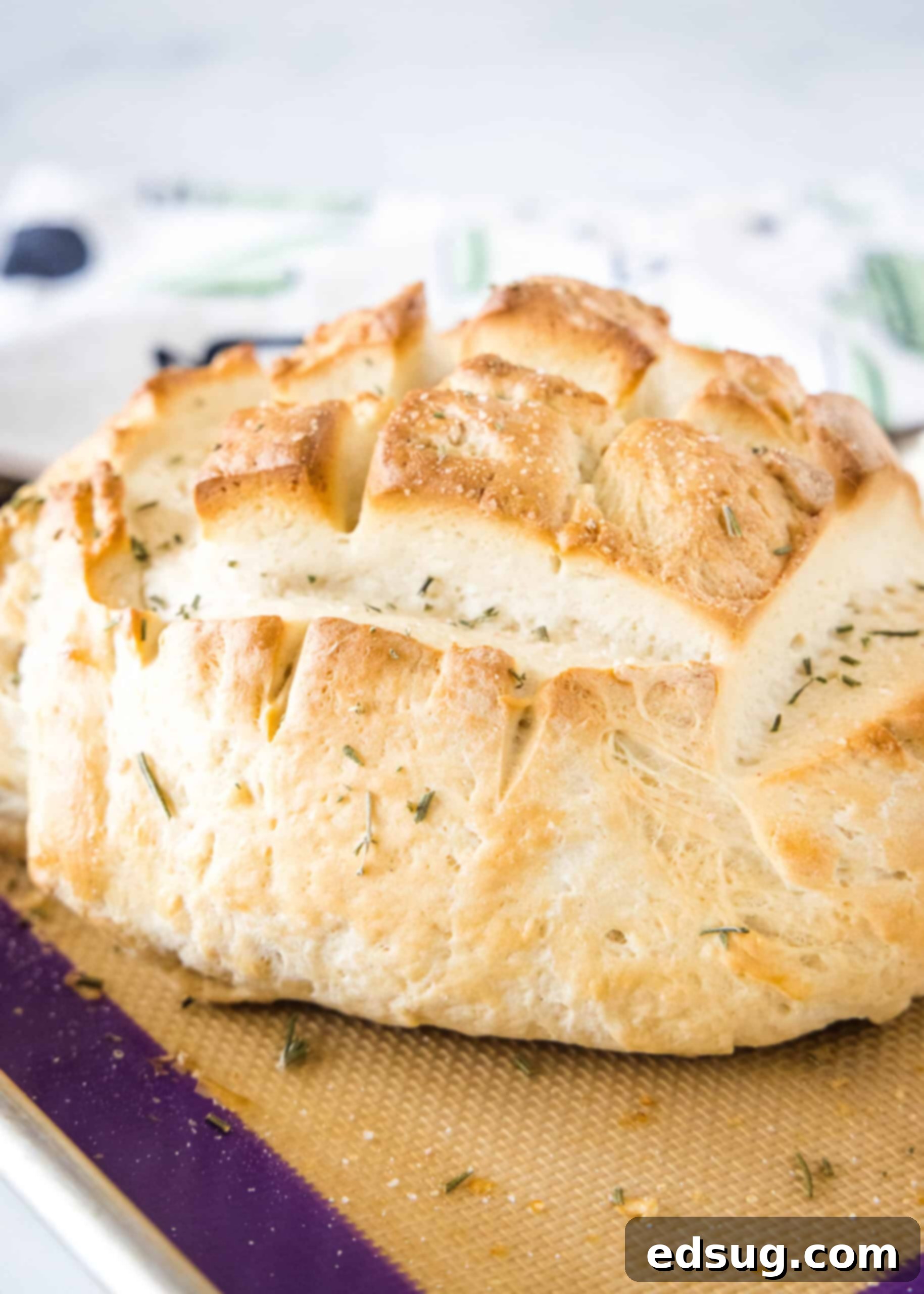 A perfectly baked, golden-brown Amish bread loaf cooling on a wooden cutting board, ready to be sliced and enjoyed.