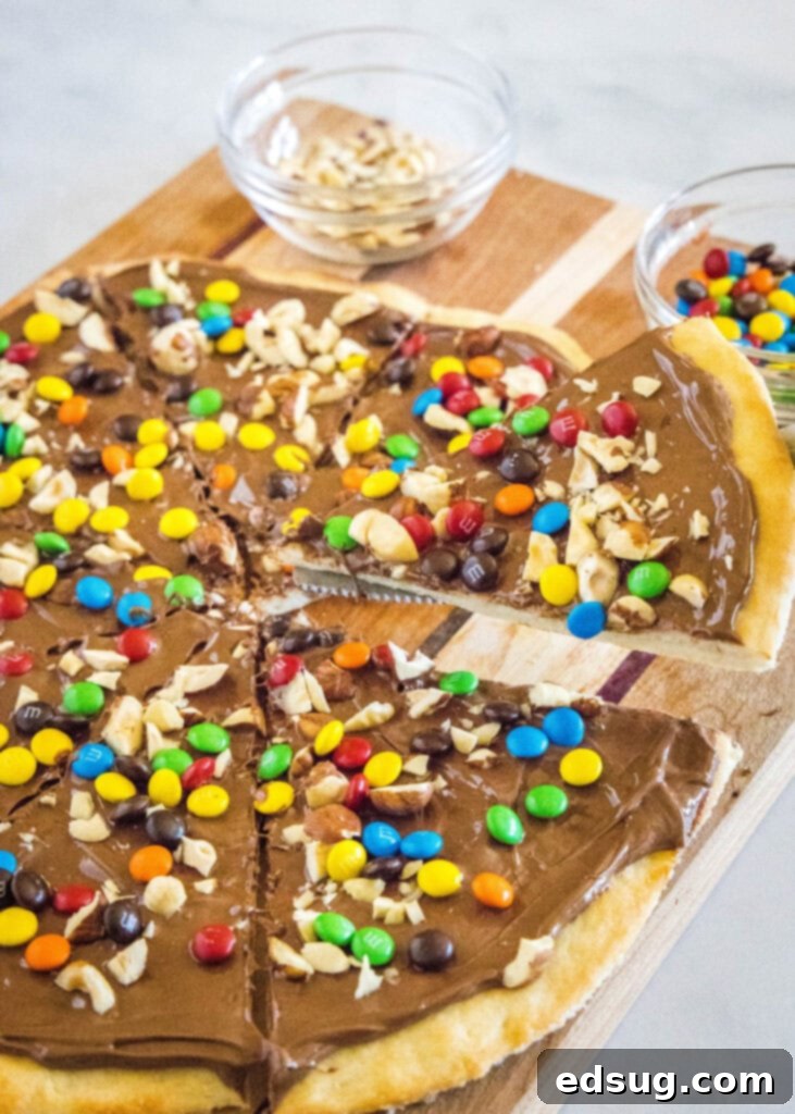 taking a slice of chocolate pizza off a cutting board