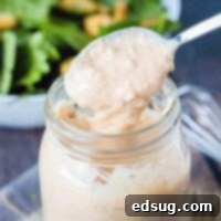 cropped close up of spooning dressing out of a jar