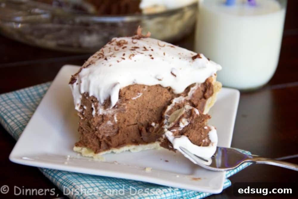 French Silk Pie with chocolate shavings on top, showcased on a wooden surface.