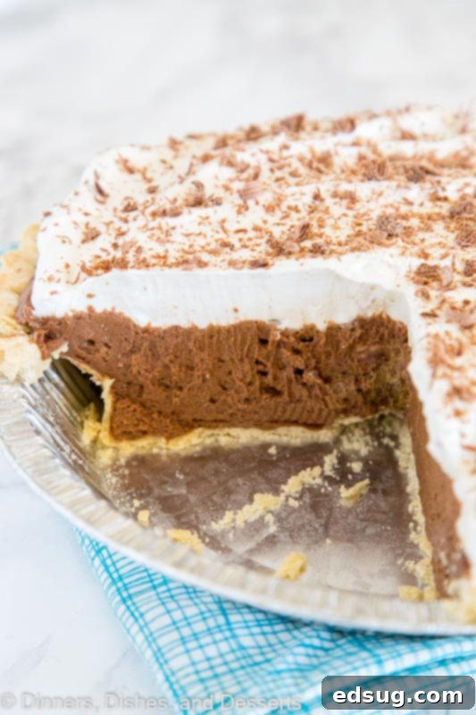 Close-up of a French Silk Pie slice, perfect for sharing on Pinterest, highlighting the rich chocolate filling and whipped cream.