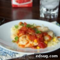 tilapia with tomatoes and orzo on a plate