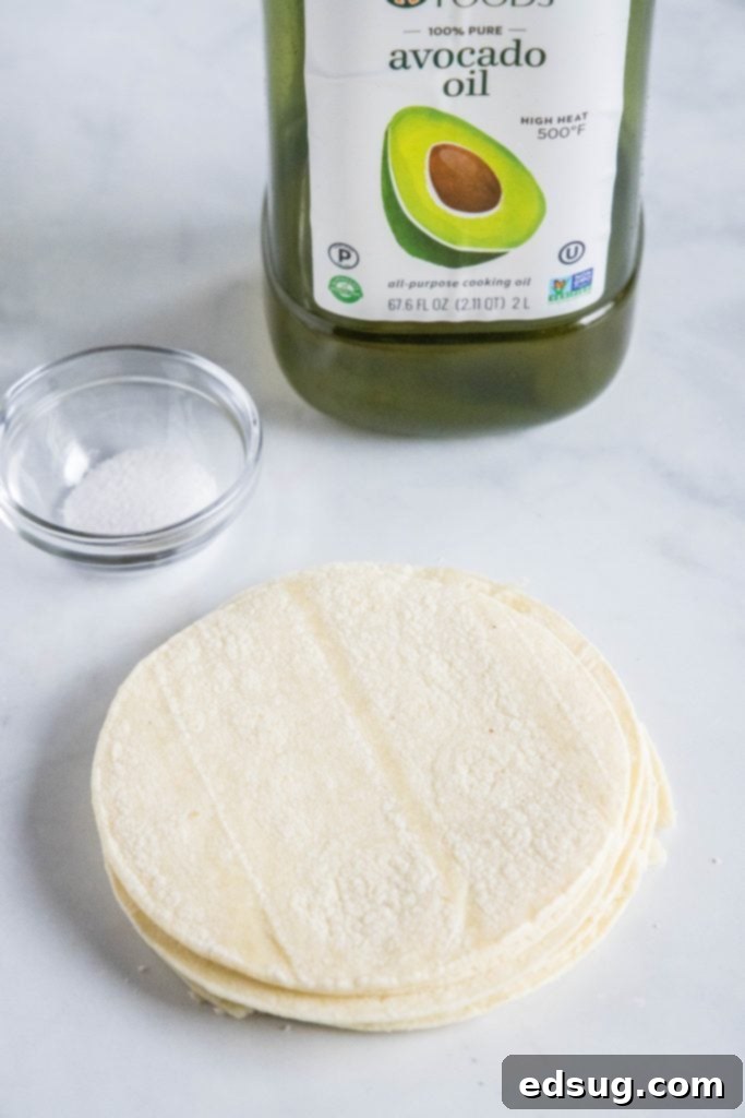 three simple ingredients: corn tortillas, a bottle of oil, and a small bowl of salt