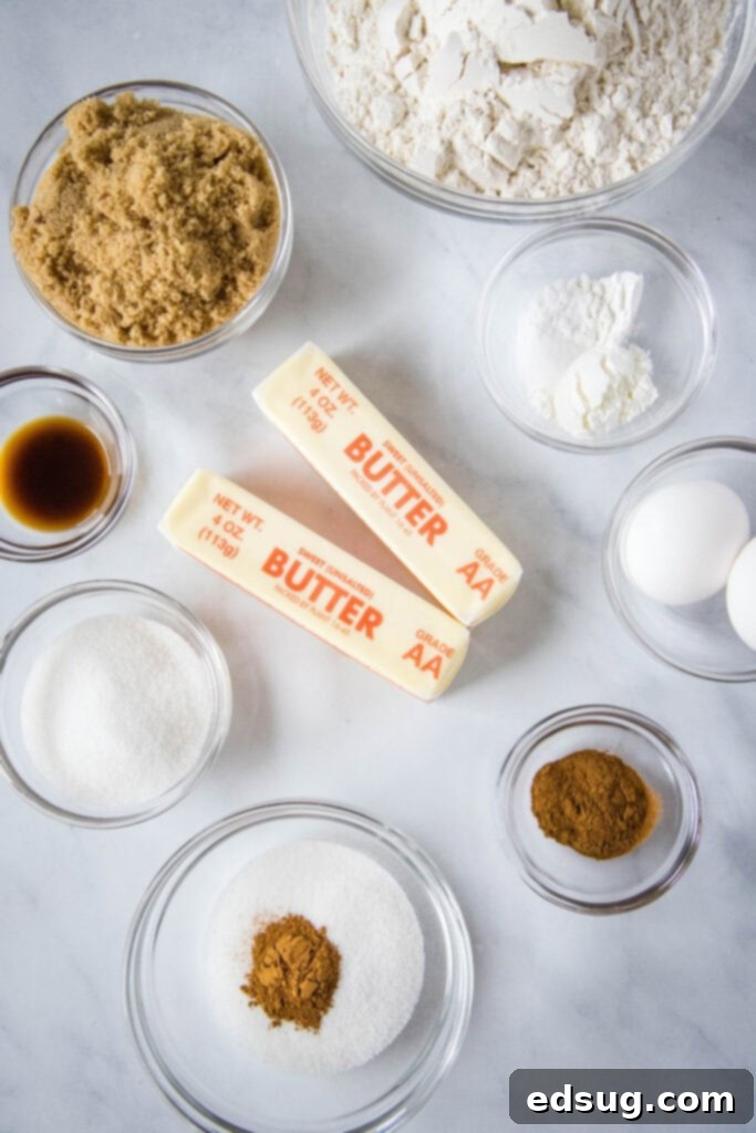 An array of baking ingredients for churro cookies laid out neatly on a wooden surface.