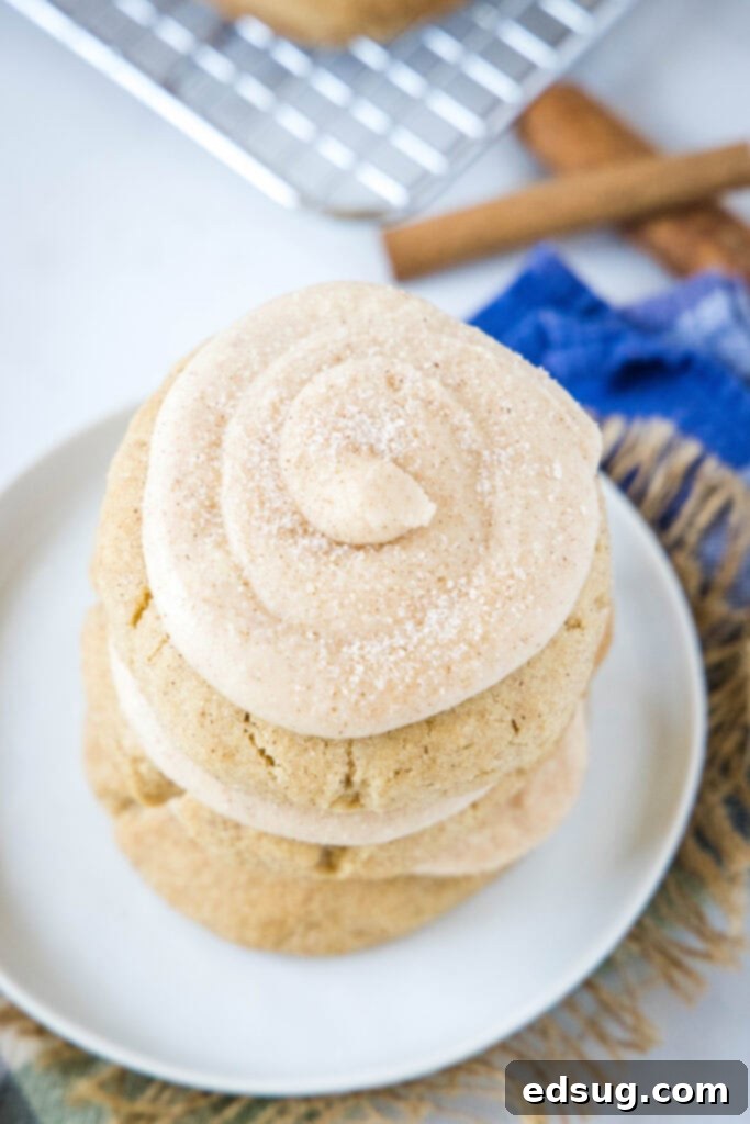 An inviting overhead view of a white plate piled high with frosted churro cookies, ready to be served.