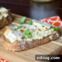 Artichoke Pesto Chicken Open Face Sandwich 2 open faced chicken sandwich with artichoke pesto on a board