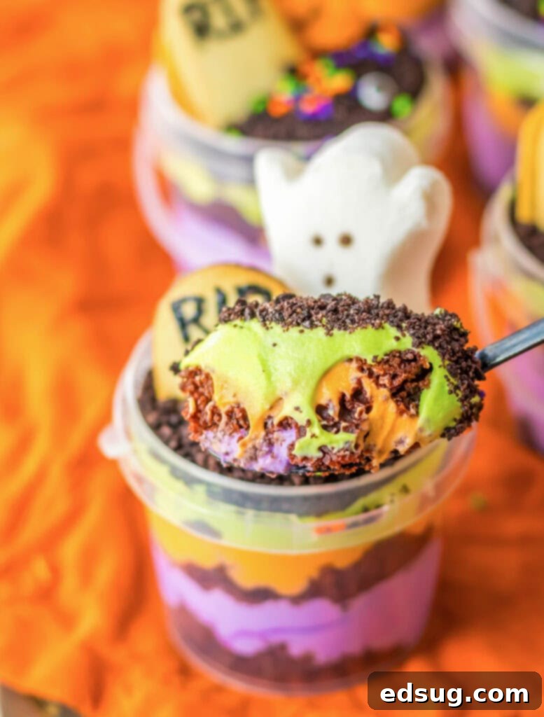 A spoonful of Graveyard Halloween Pudding Cup showing layers of cake and pudding