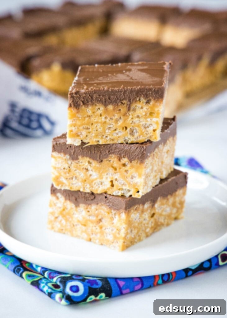 biscoff krispie treats stacked on a white plate