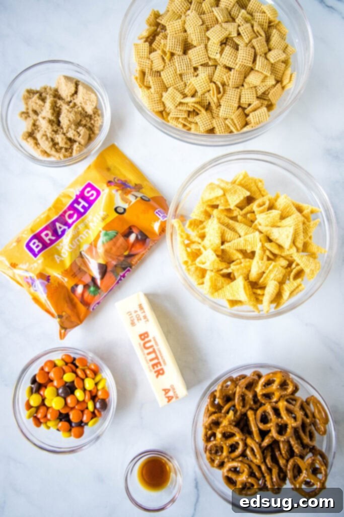 Close-up of the Chex cereal, Bugles, and pretzels mixture before baking, coated in the sweet butter sauce.