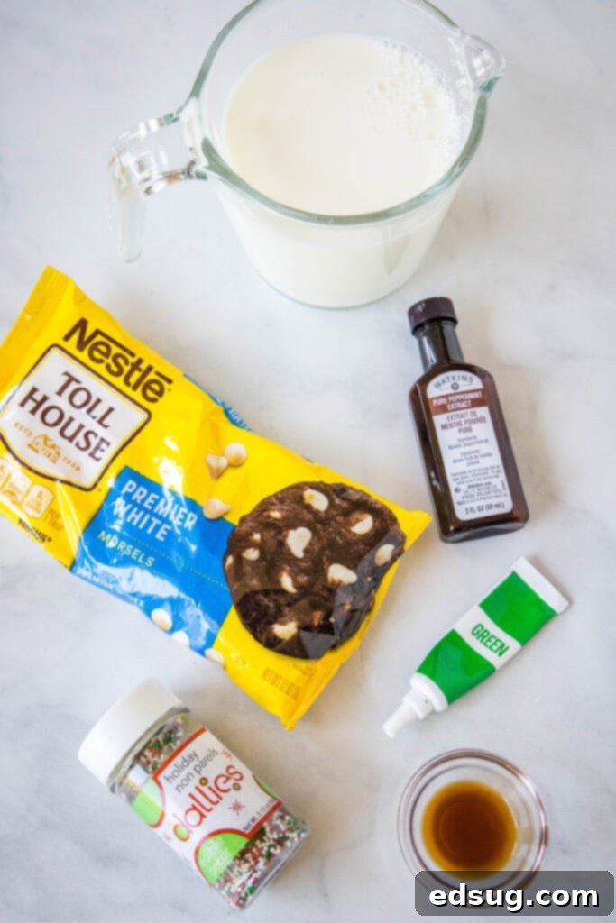 Ingredients laid out for making Grinch Hot Chocolate, including milk, white chocolate, peppermint extract, vanilla extract, and green food coloring.