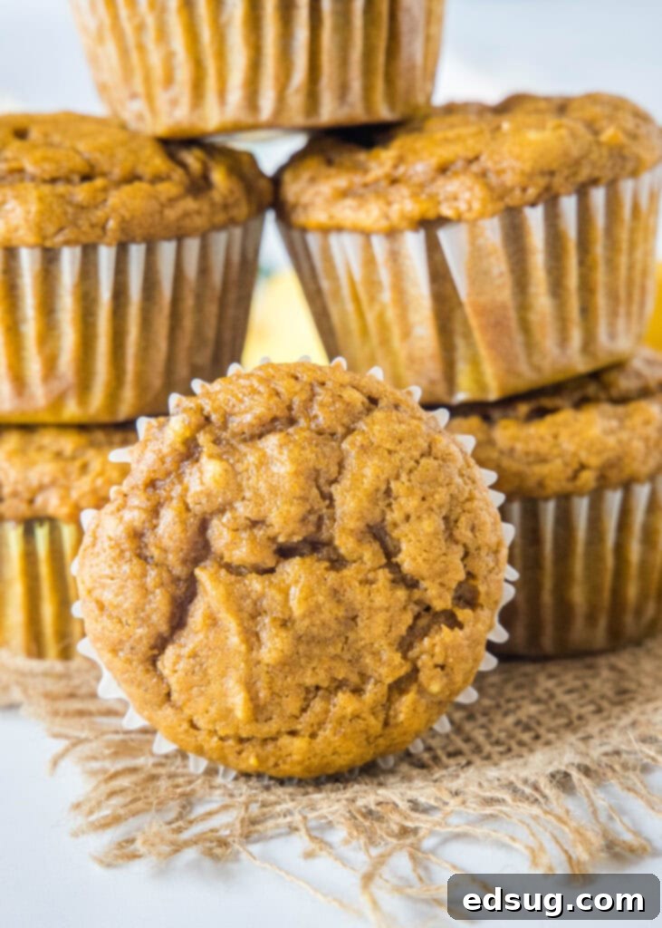 Spiced Pumpkin Banana Muffins 5 Stacked pumpkin banana muffins, showing off their fluffy texture.