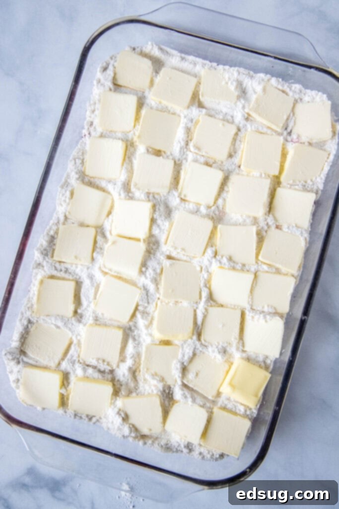 pats of butter ontop of cake mix in baking pan