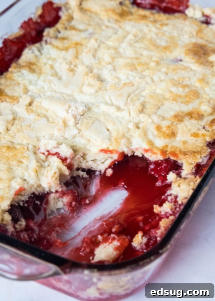 strawberry dump cake baked in pan with pieces missing