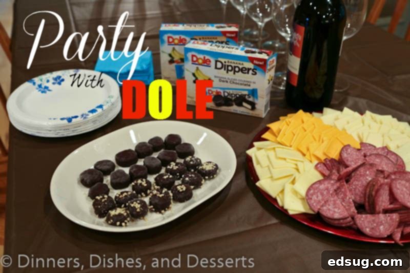 A vibrant and joyful family gathered for a party, with a table laden with snacks and the star dessert, DOLE Banana Dippers.