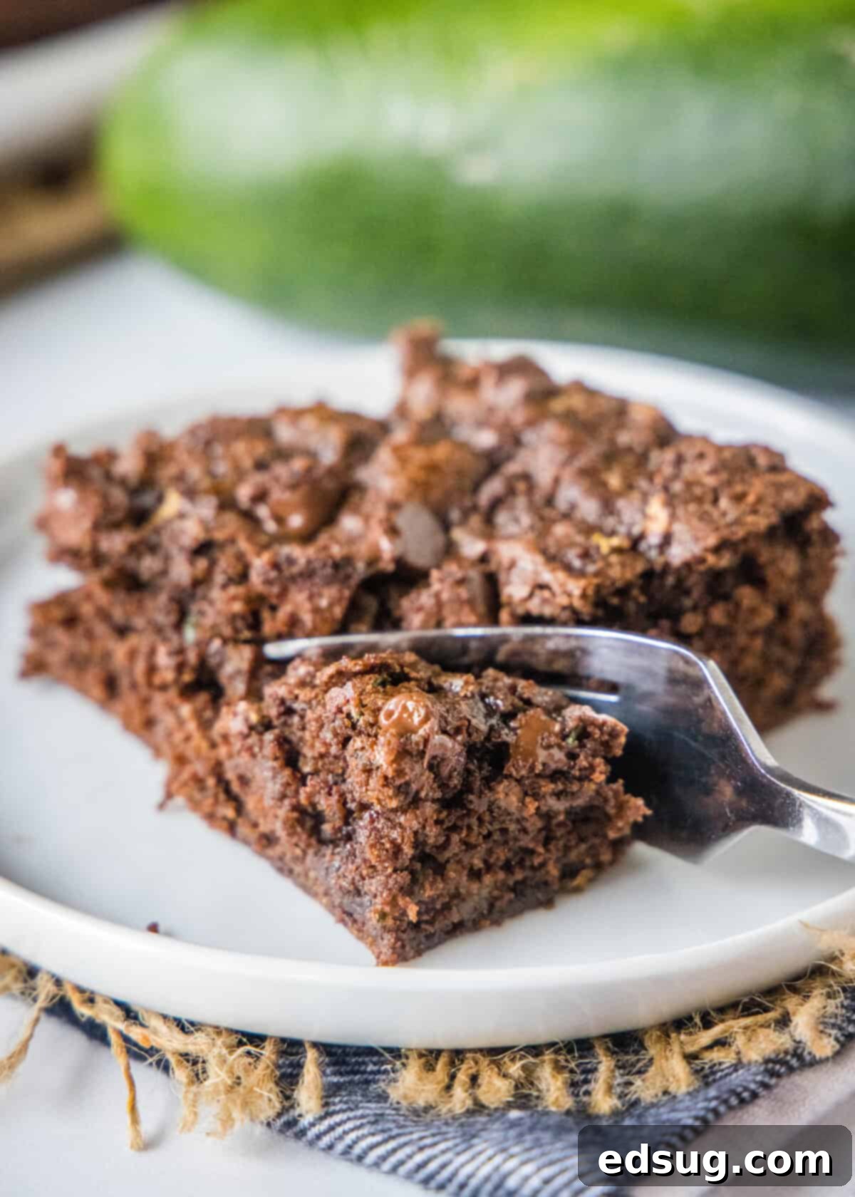 A fork taking a bite out of a fudgy zucchini brownie