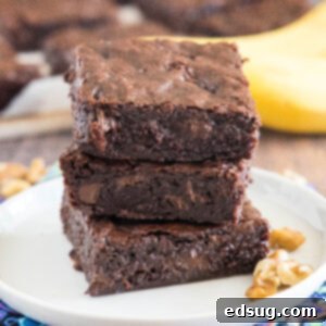 cropped close up banana brownies stacked on a white plate
