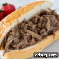 Slow Cooker Italian Beef - use your crock pot to make these super tender Italian Beef Sandwiches. Cooks all day in great spices, for a tender and flavorful dinner. 