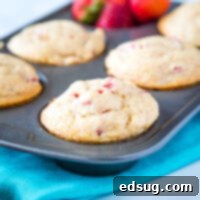 Strawberry Muffins - a quick and easy muffin recipe with lots of fresh juicy strawberries.  Slightly sweet, tender and absolutely delicious.  Great to freeze and have on hand for busy mornings!