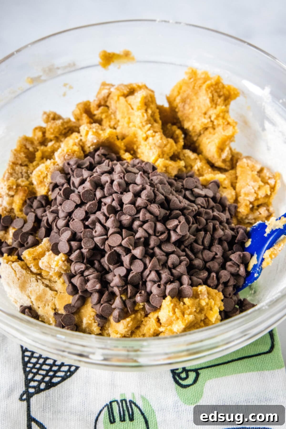 Spiced Chewy Pumpkin Chocolate Chip Cookies 5 Adding chocolate chips to the pumpkin cookie dough in a mixing bowl