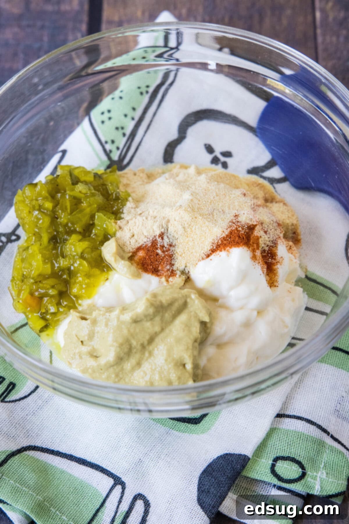 All the Big Mac Sauce ingredients carefully combined in a clear glass bowl, showing the creamy texture and small bits of relish.