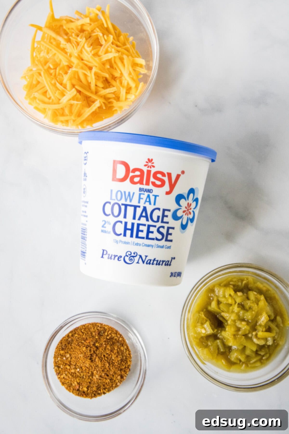 cottage cheese and other ingredients for queso laid out on a cutting board