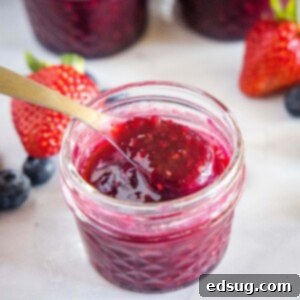 Berry Medley Jam 10 spooning out jam from a small jar