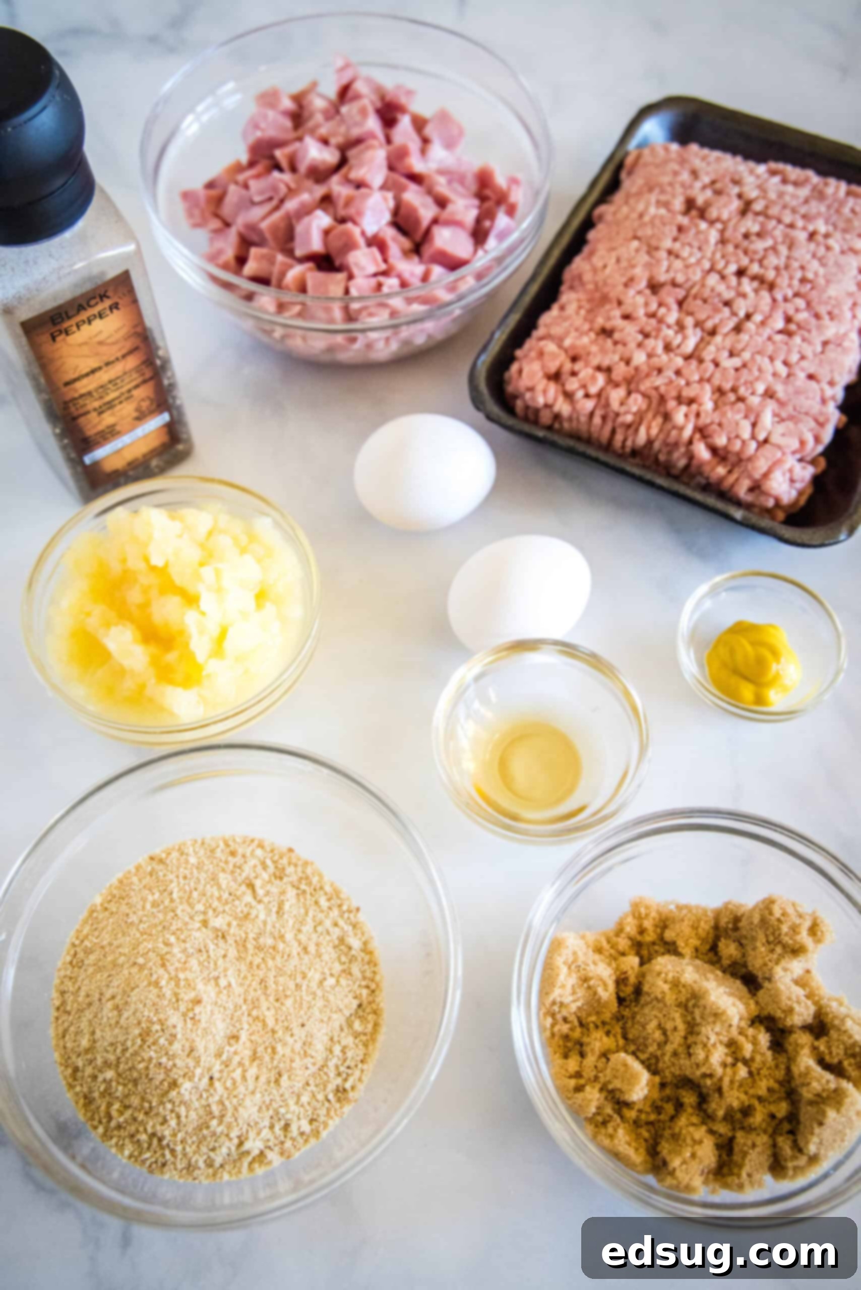 Essential ingredients laid out for making delicious ham balls and their two sauce options.