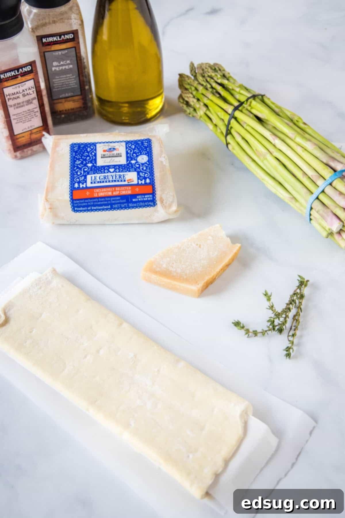 all ingredients for asparagus tart laid out on a kitchen counter