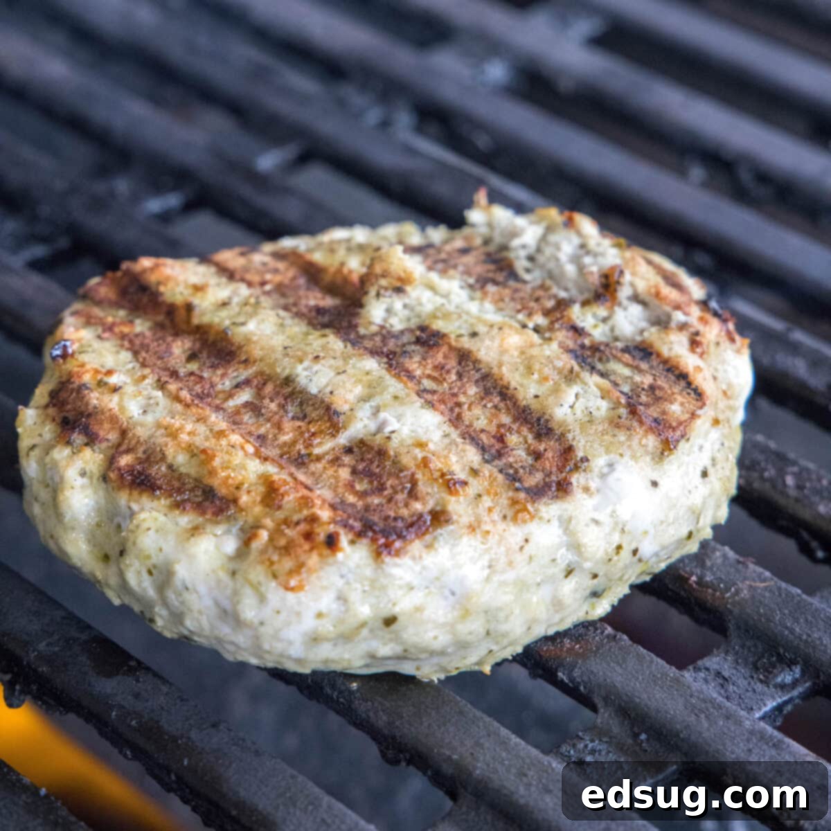 chicken burger cooking on the grill