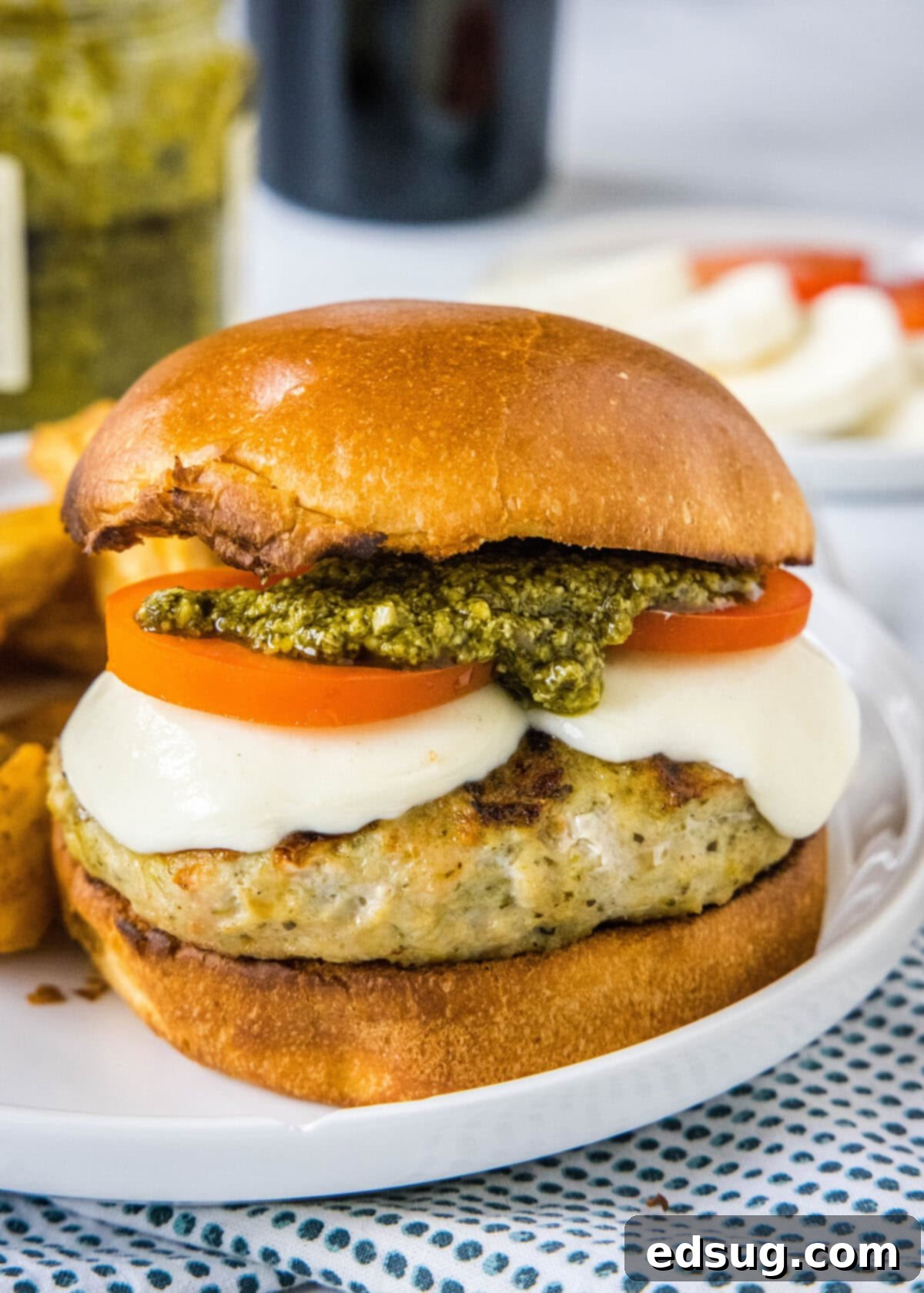 finished pesto chicken burger on a white plate