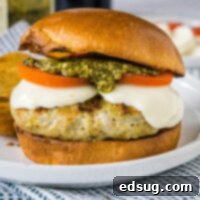 pesto chicken burger up close on a white plate