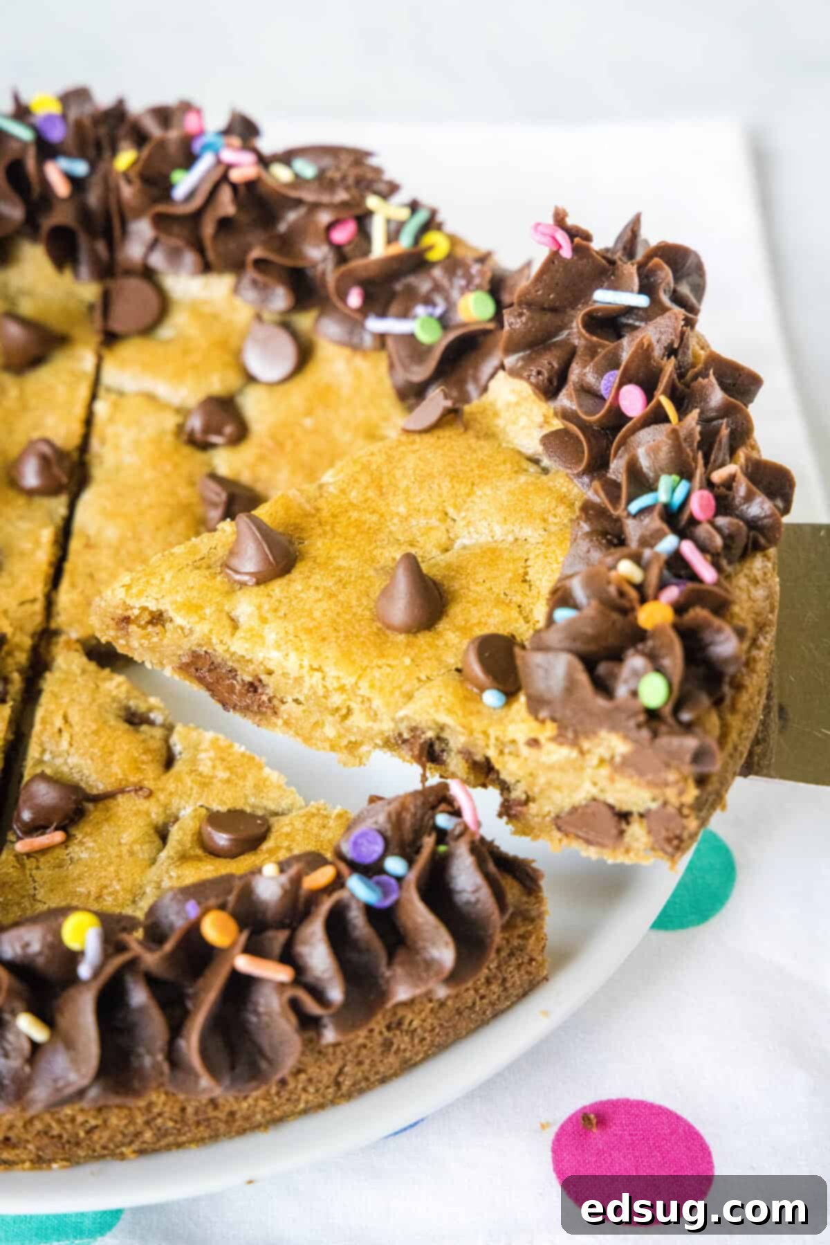 Serving a delicious piece of homemade cookie cake from a large platter, a crowd-pleasing dessert.