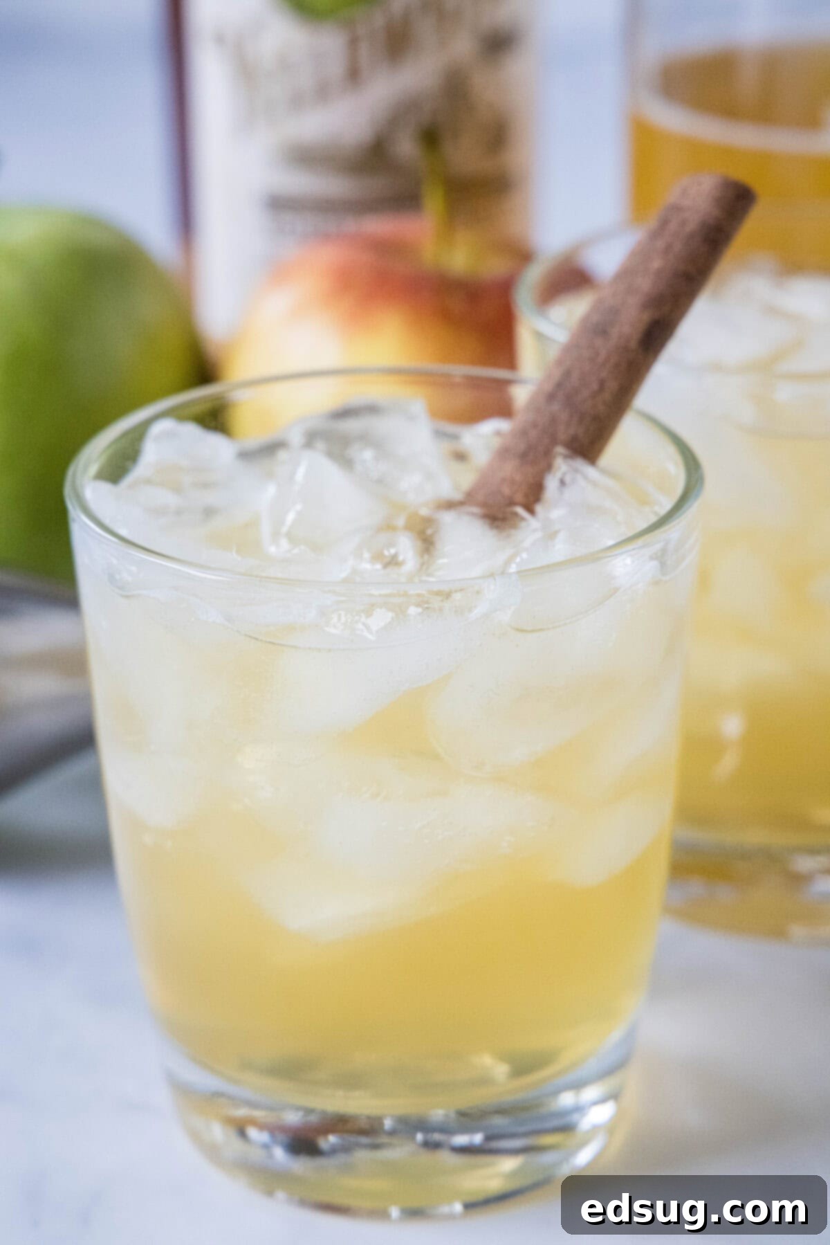 Delicious Bourbon Apple Cider Cocktail in a glass, garnished with a cinnamon stick