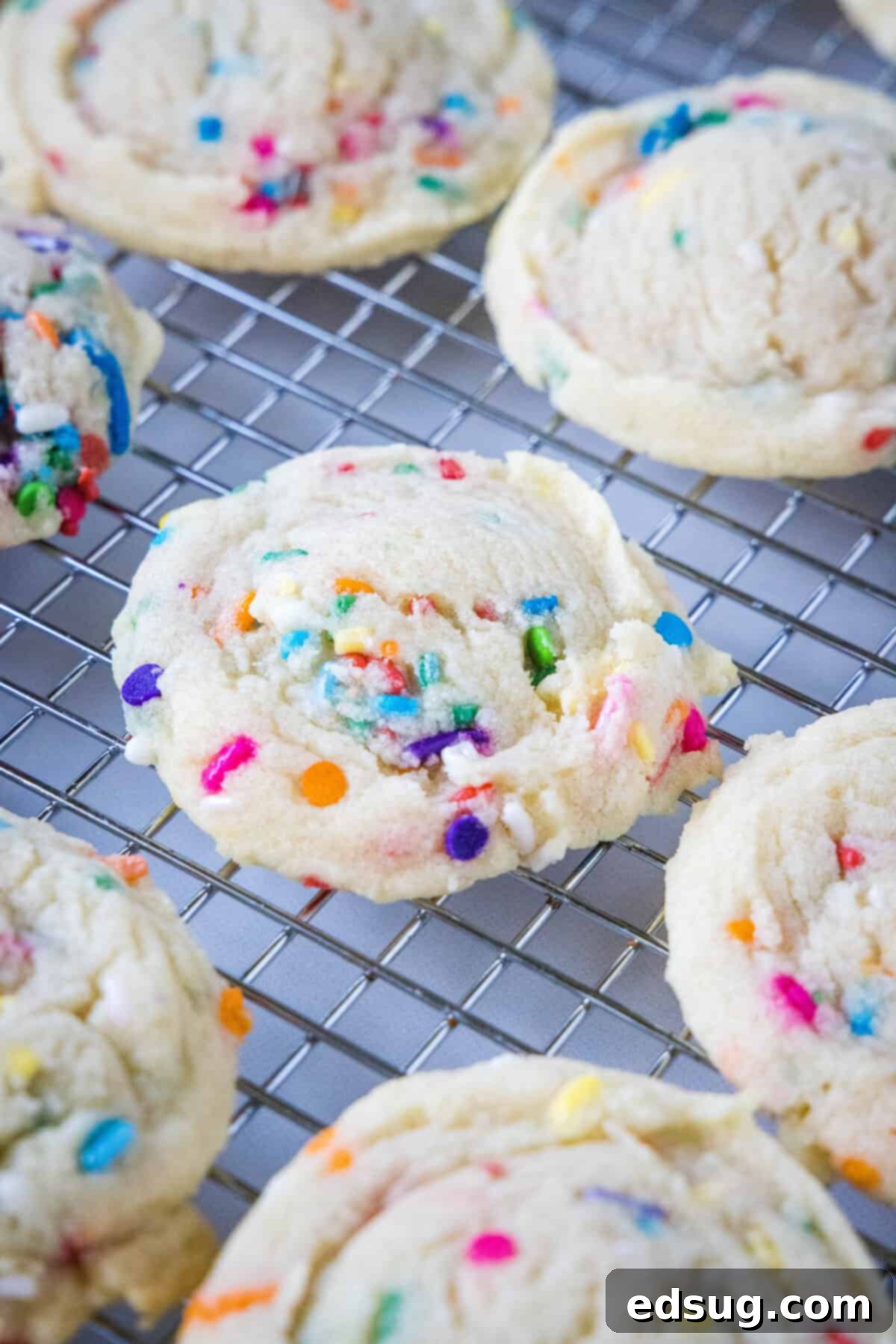 Whimsical Confetti Bites 5 Freshly baked Funfetti cookies cooling on a wire rack, ready to be devoured.