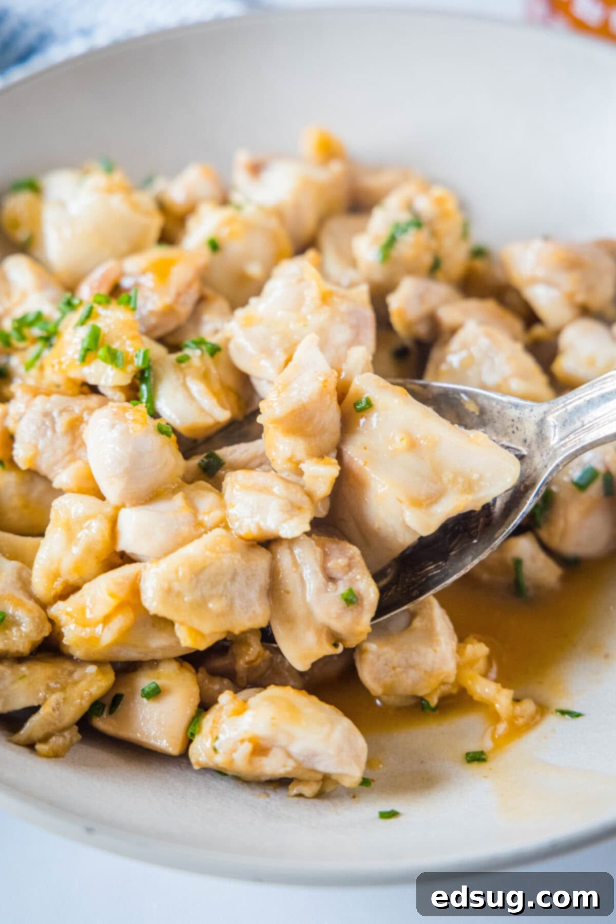 spooning chicken bites out of a bowl