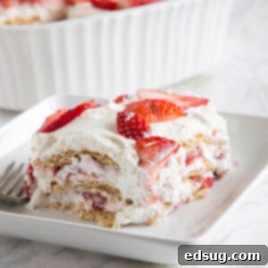 Close up of a slice of Strawberry Ice Box Cake on a white plate