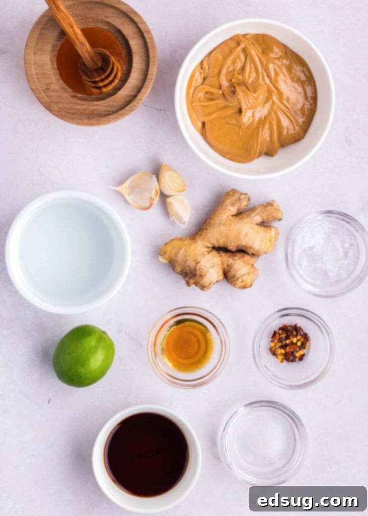 ingredients for homemade peanut dressing, including peanut butter, honey, soy sauce, and lime juice