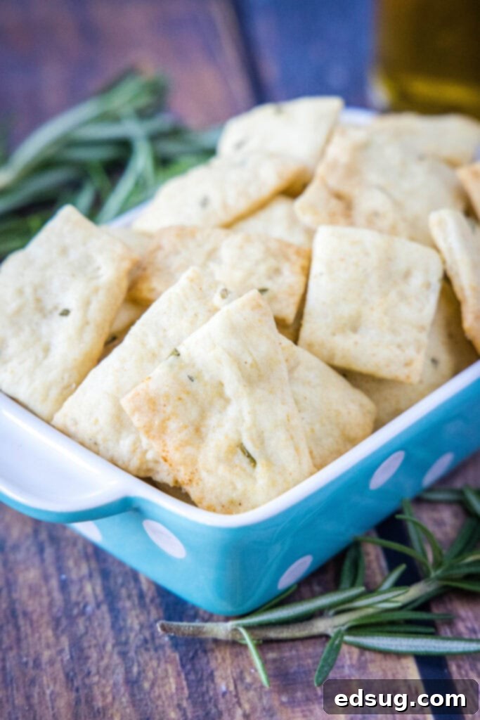 Mediterranean Rosemary Olive Oil Crackers 2 Close up of a bowl of freshly baked, golden-brown rosemary and olive oil crackers, showcasing their crisp texture.