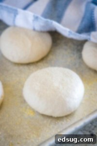 Golden Griddled Goodness 12 raw english muffins on baking sheet