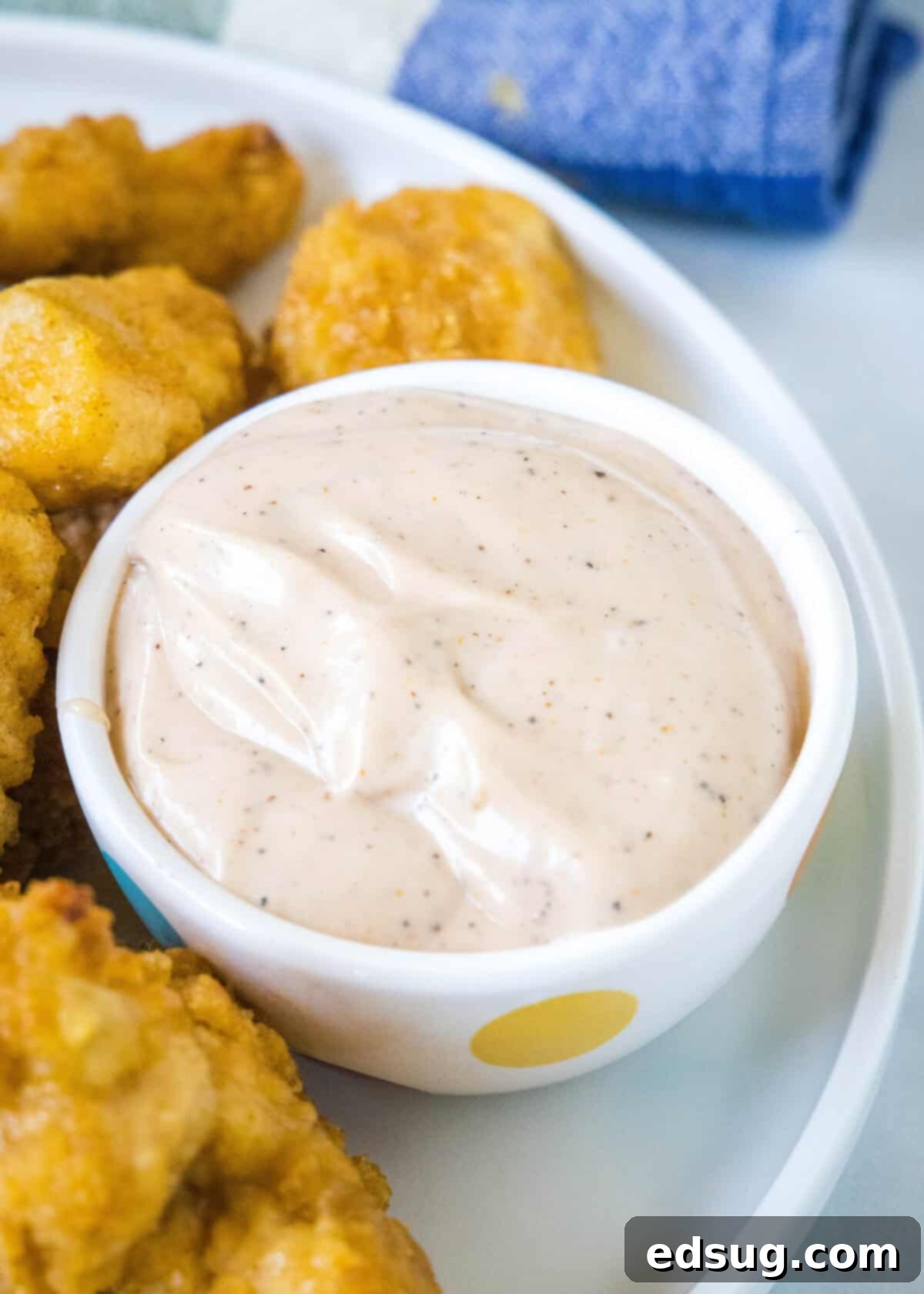 Copycat Canes Sauce Recipe 2 canes sauce in a bowl with golden chicken nuggets around it