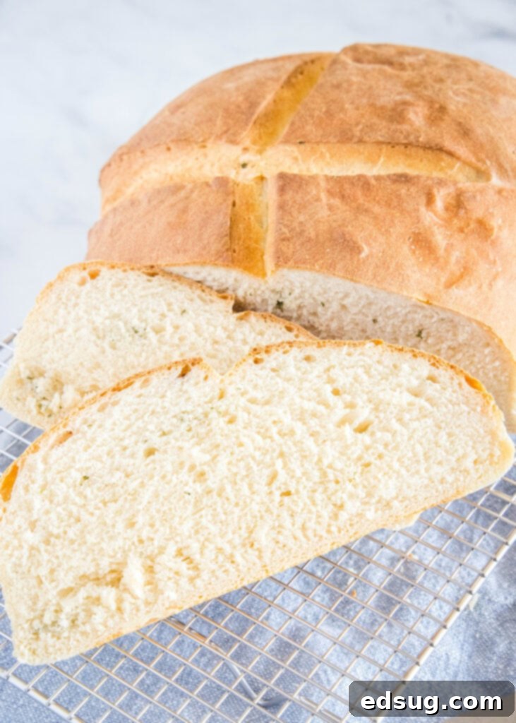 Savory Potato Chive Loaf 5 Several slices of freshly baked potato bread arranged on a wire cooling rack.