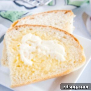 Savory Potato Chive Loaf 7 cropped close up of sliced of bread with butter