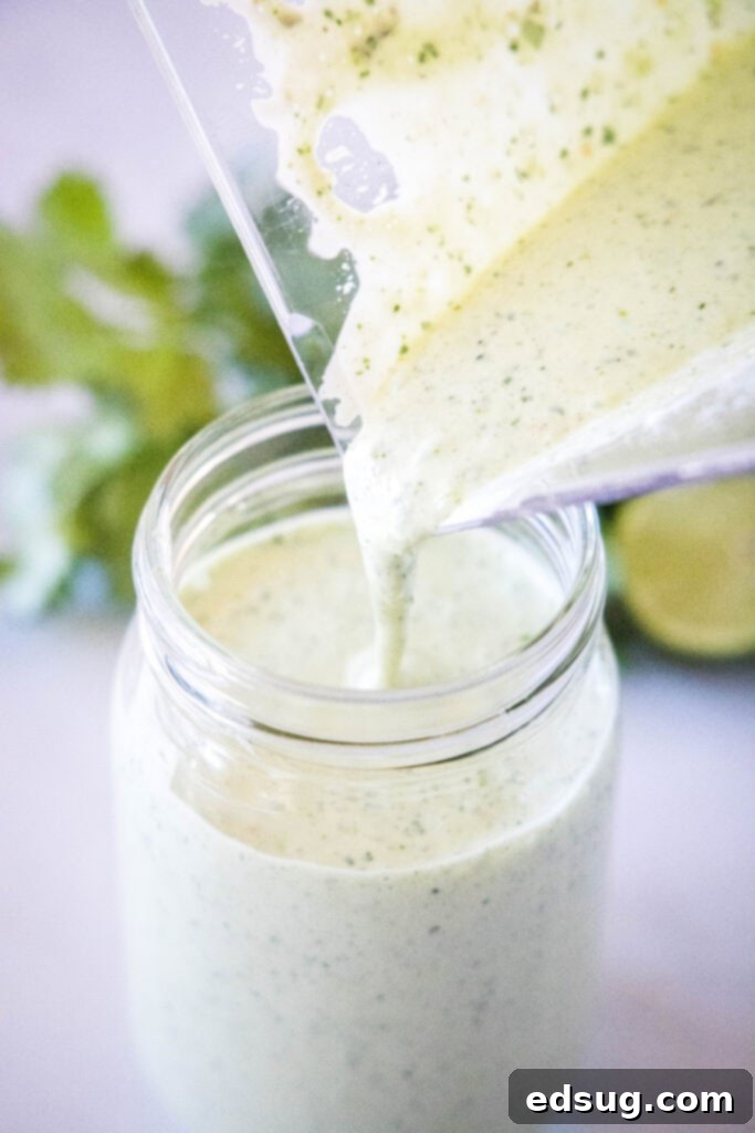 Signature Cafe Rio Dressing 4 pouring tomatillo ranch dressing from blender into a glass jar