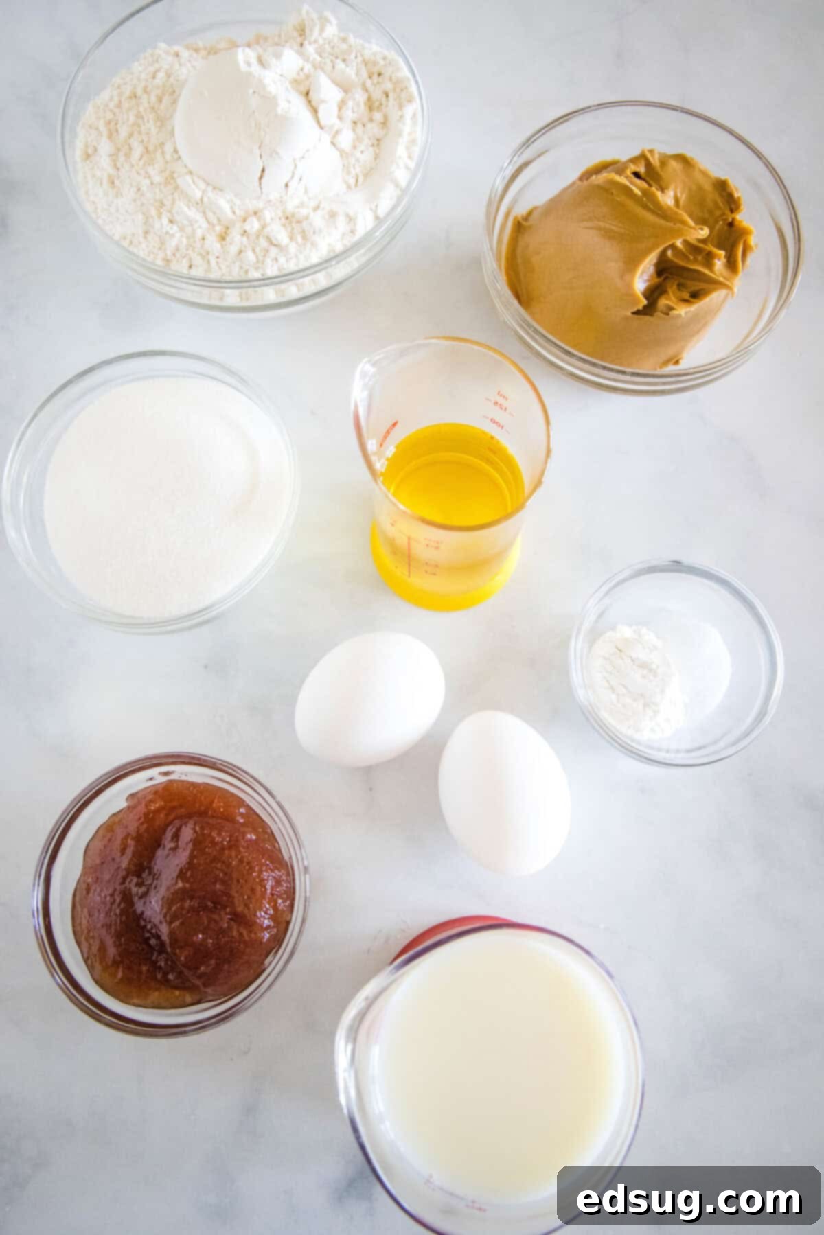 Peanut Butter and Jelly Swirl Muffins 3 Peanut butter and jelly muffin ingredients laid out on a table