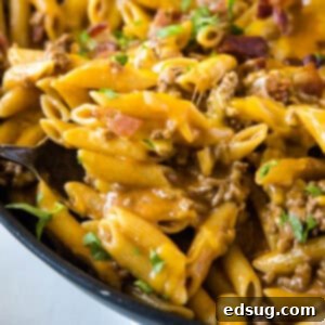 cropped close up bacon cheeseburger pasta in skillet
