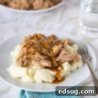 Tender Slow Cooker Pork Roast 2 A plate of food on a table, with Cooker and Pork