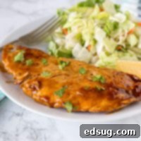 Turkey cutlet in a lemon sauce with parsley on a white plate