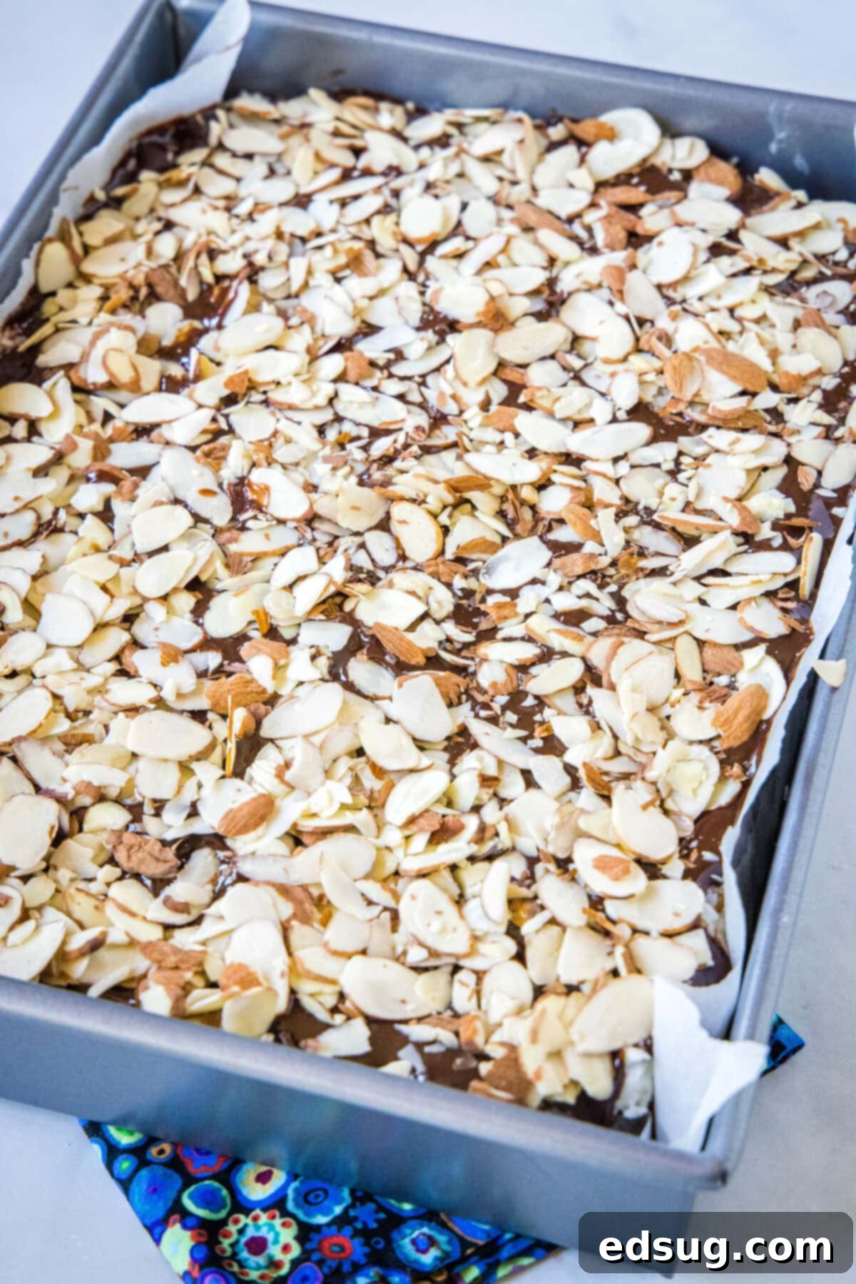 Ultimate Almond Joy Brownies 4 a baking pan filled with almond joy brownies, ready to be sliced