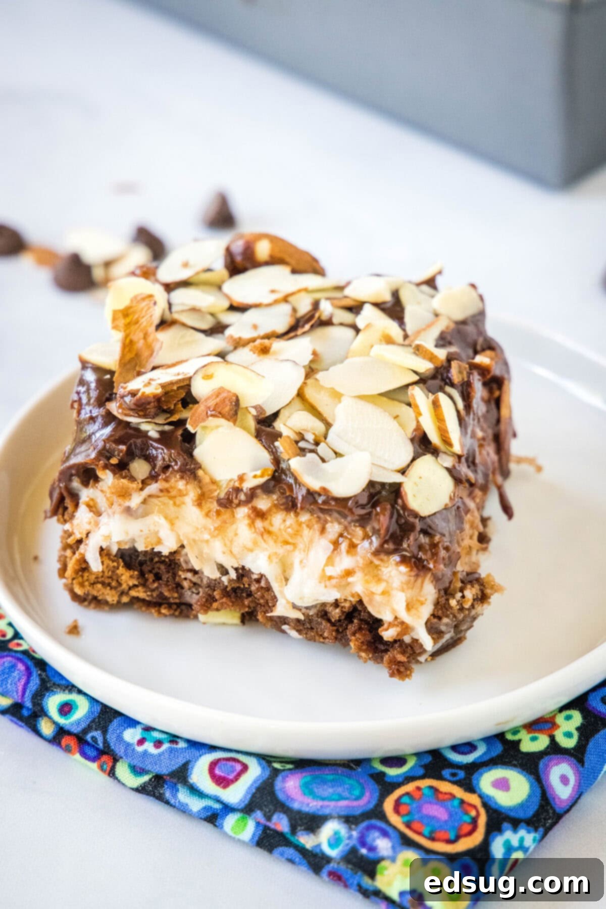 Ultimate Almond Joy Brownies 6 single almond joy brownie on a white plate