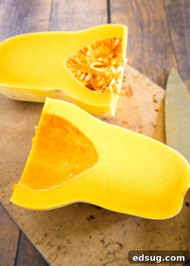 butternut squash cut in half with seeds scooped out of half